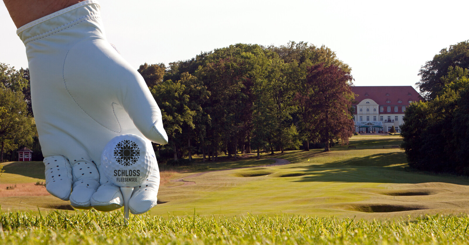 Golfball des Schloss Fleesensee Golfkurses vor der Kulisse des Schlosses.